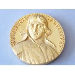 A heavy gilt-bronze medallion depicting Napoleon I in relief (9.5cm diameter) (The cost of UK