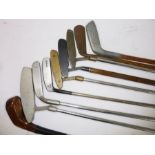 Nine golf putters; hickory and metal shafted in a Ping golf bag