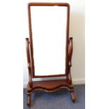 A mid-19th century mahogany cheval mirror, the mirror plate with cushion-moulded frame