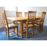 A good modern solid oak extending dining table having cleated ends and raised on square legs