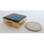 A small gilt-metal snuff box; set with a rectangular lapis lazuli top (3.5cm wide)