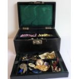A mid-20th century green leather-bound jewellery box containing various costume jewellery to include