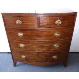 An early 19th century bow-fronted mahogany chest; caddy top, two half-width over three full-width