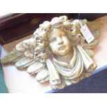 A 19th century ormolu bracket with a cherub's face surrounded by feather design, in original