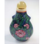 A baluster-shaped Chinese porcelain snuff bottle; green hardstone stopper, the body decorated with