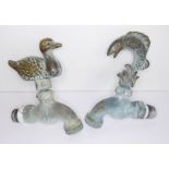 A pair of novelty brass taps; one modelled as a leaping fish, the other as a mallard