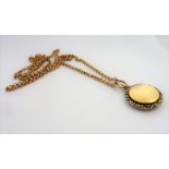 A Victorian 9-carat gold photo locket and chain (total weight 18g) (The cost of UK postage via Royal