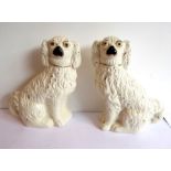 A pair of 19th century Staffordshire spaniels with gilded leads (25cm high)