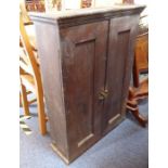 An 18th/19th century oak side cabinet; two fielded-panel doors enclosing shelves etc. (95cm wide x