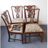 A set of four George III period mahogany salon chairs; each with pierced splat, later drop-in