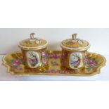 A 19th century porcelain double inkwell on stand; decorated with pink roses against a gilded