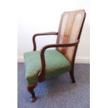 A 1920/1930s stained-wood open armchair with rattan-caned back, stuff-over Art Deco-design