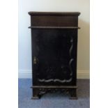 A heavy rosewood cupboard/plinth, the carved gadrooned top above a single door with shaped panel,