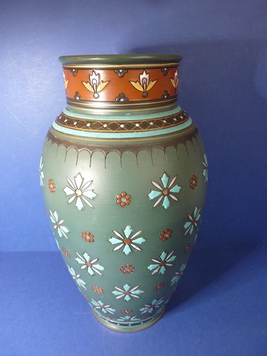 A late 19th century Mettlach porcelain vase; hand-decorated in enamels with stylised flower heads (