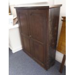 A 19th century stained-wood side cabinet; the outset cornice above two panelled doors enclosing