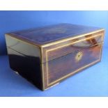 A mid-19th century rosewood and gilt-brass-mounted vanity case; the hinged lid opening to reveal