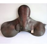 A brown-leather racing saddle in used condition