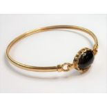 A 9-carat gold stone-set bangle (5.6g) (The cost of UK postage via Royal Mail Special Delivery for