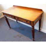 A late Regency period mahogany writing table; galleried thumbnail-moulded top above two half-width