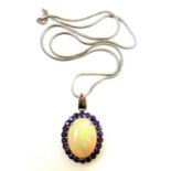 A fine quality large opal and amethyst cluster pendant on heavy 14-carat gold frame (The cost of