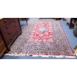 A good and large hand-knotted Persian carpet; predominately blue and red ground, with flower heads
