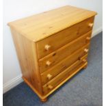 A modern four-drawer pine chest on bun-style feet (86cm wide x 45cm deep)