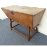 A 19th century sarcophagus-shaped oak dough bin on stand (restorations)