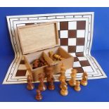 A cased boxwood chess set (PLEASE NOTE; ONE 'DARK' PAWN MISSING) together with a linoleum travelling
