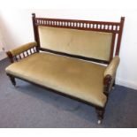 A late 19th century Aesthetic-style walnut and upholstered sofa on turned front legs with castors