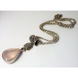 A good and heavy silver-set pink hardstone pendant suspended from an ornate loop and heavy chain (