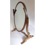 An oval mahogany-framed toilet mirror