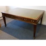 A large George III style (later) mahogany partner's library table; the green leather and gilt-tooled