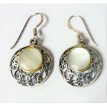 A pair of circular pierced silver and mother of pearl mounted earrings (The cost of UK postage via