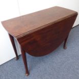 A late 18th century/early George III period oval drop-leaf Cuban mahogany gate-leg table; raised