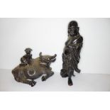 An early 20th century Chinese hardwood carving of a recumbent water buffalo with a boy climbing upon