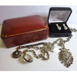 A red morocco and gilt-tooled jewellery box containing a small amount of costume jewellery, together