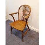 A mid-19th century Windsor chair; yew-wood splat and bow-shaped elm seat, turned tapering slightly