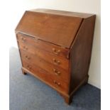A late 18th century mahogany writing bureau; the cleated fall opening to reveal fitted interior with