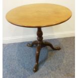 An 18th century circular mahogany one-piece tilt-top tripod table with birdcage mechanism; turned