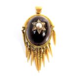 A 19th century yellow-metal pendant, the oval cabochon garnet centrally set with a pearl flanked