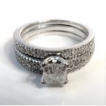 An 19-carat gold multi-diamond two-piece engagement ring; the centre princess-cut diamond