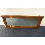 An early 20th century walnut-framed overmantle mirror; dentil cornice above a carved fruiting vine