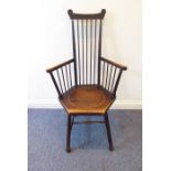 An early 20th century Arts and Craft style stick-back chair of primitive inspiration; dished