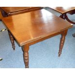 An early 20th century extending mahogany dining table having reeded edged top and four turned
