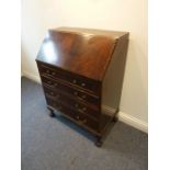 An early 20th century mahogany writing bureau; the gadrooned fall above four full-width drawers