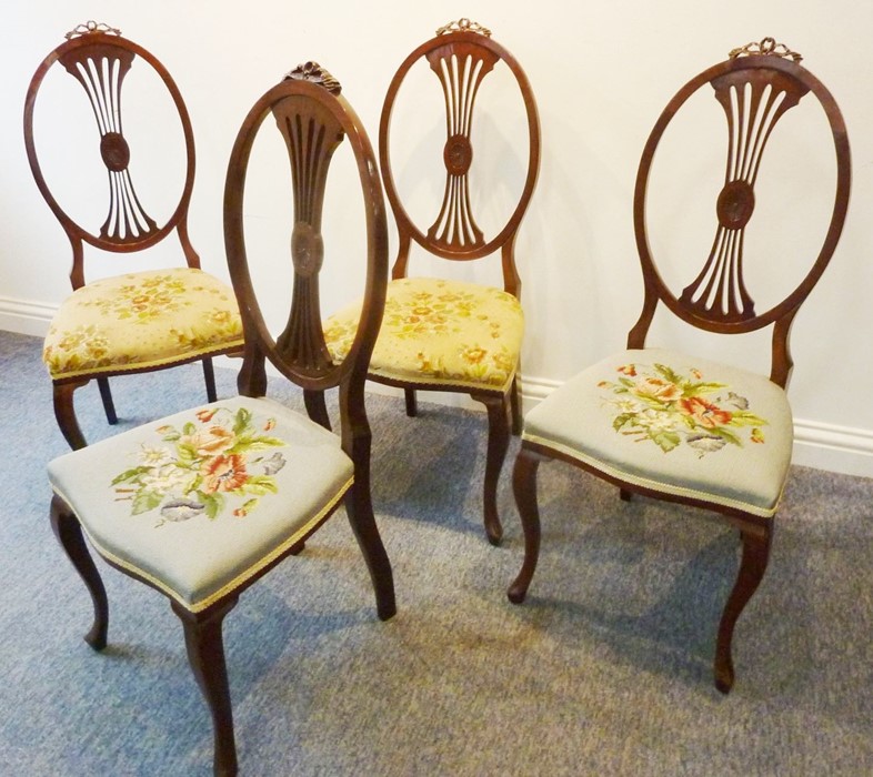 A set of four Edwardian salon chairs in late 18th century Hepplewhite style; the oval backs with