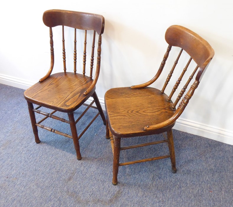 A pair of late 19th/early 20th century kitchen-style chairs; each with concave top rail above turned