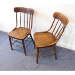 A pair of late 19th/early 20th century kitchen-style chairs; each with concave top rail above turned