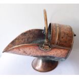 A 19th century helmet-shaped copper coal scuttle