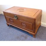 A mid-20th century Chinese hardwood chest; carved and decorated with Shou characters and raised on